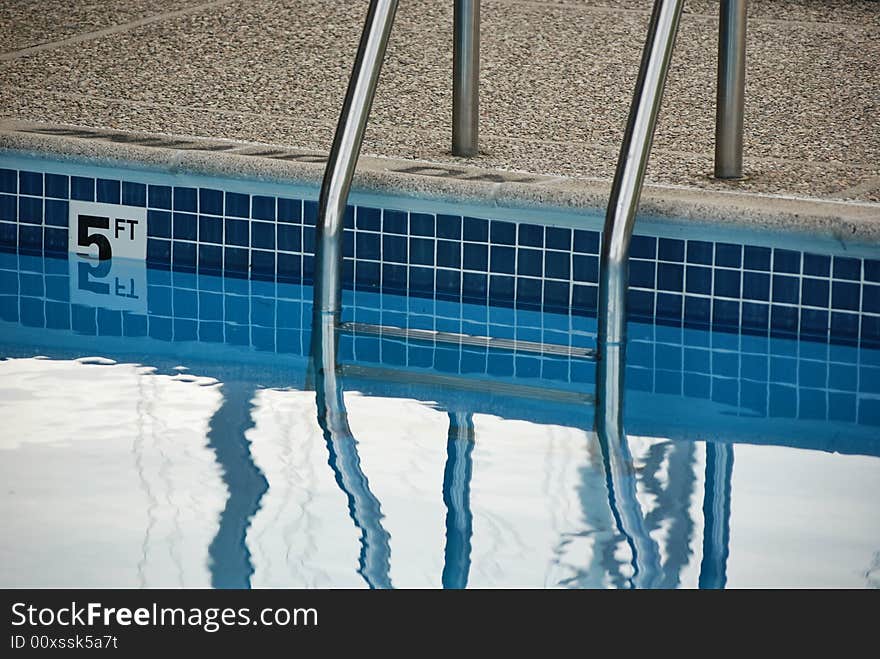 Aluminum ladder at the deep end of the swimming pool. Aluminum ladder at the deep end of the swimming pool.