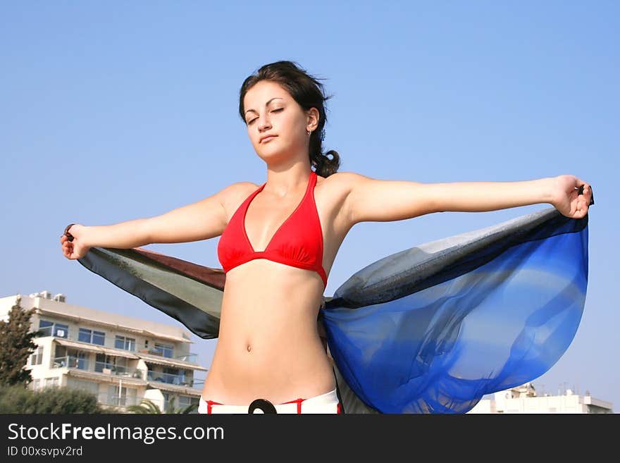 Pretty girl with pareo on the beach.