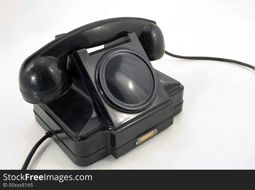 The old telephone of black colour on a white background. The old telephone of black colour on a white background.