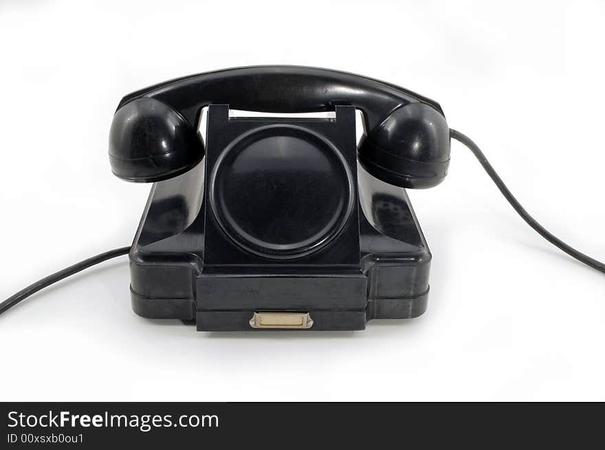 Old-fashioned black telephone receiver with cord on white background. Old-fashioned black telephone receiver with cord on white background.