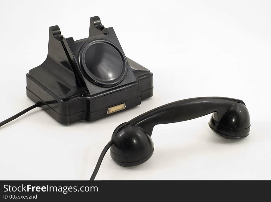 Old-fashioned black telephone receiver with cord on white background. Old-fashioned black telephone receiver with cord on white background.