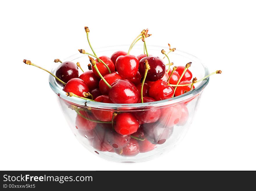 An image of ripe red cherries in a glass cup