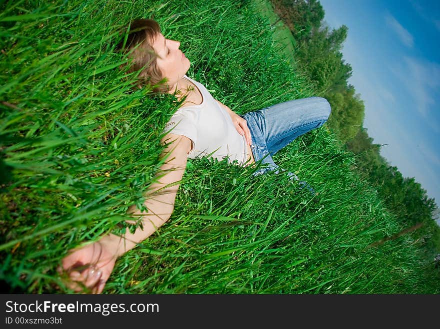 A beautiful young woman relaxing in the grass