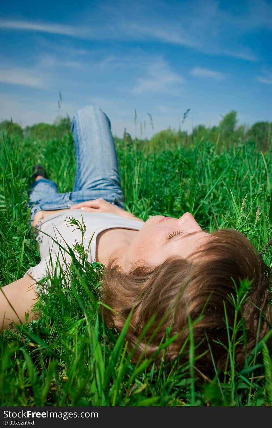 A beautiful young woman relaxing in the grass