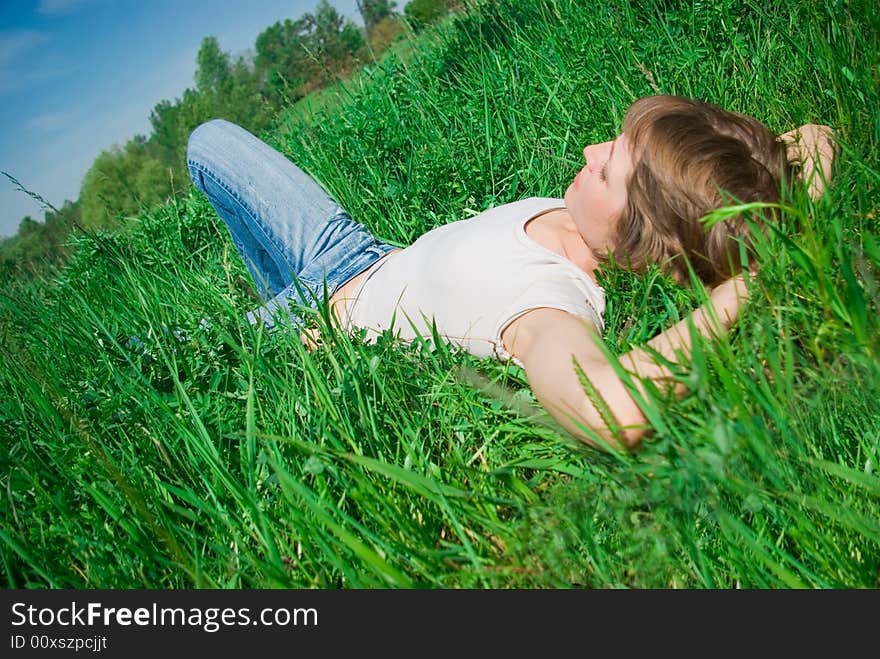 A beautiful young woman relaxing in the grass