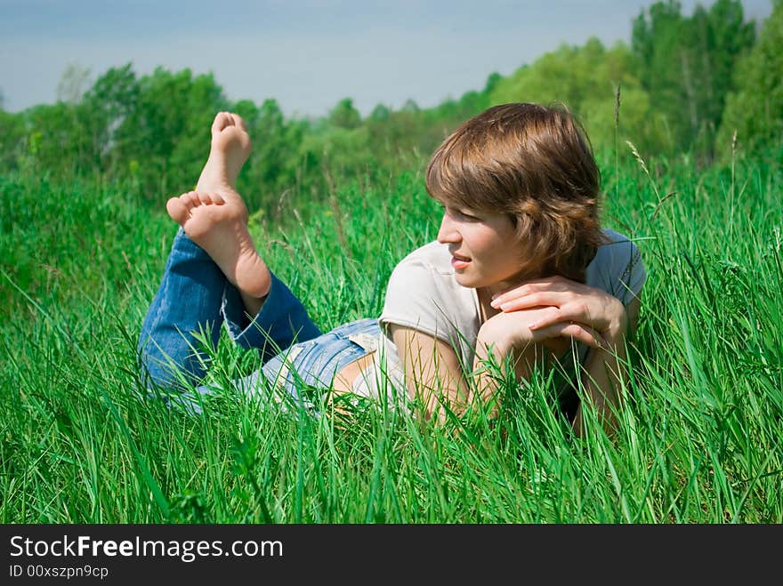 A beautiful young woman relaxing in the grass