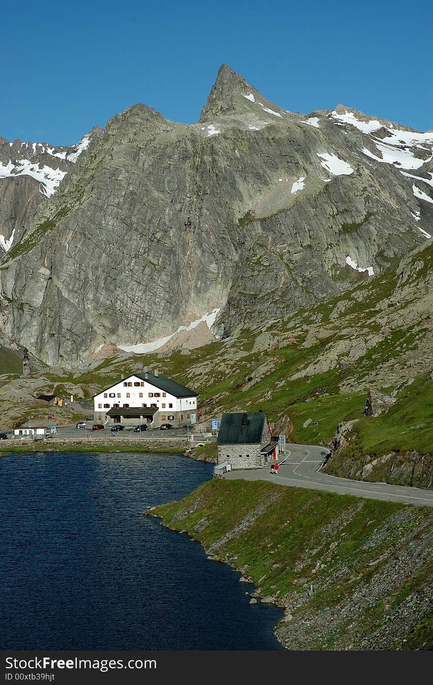 Early in the morning, landscape view of the lake and mountains at the Grand-Saint-Bernard pass between Italy and Switzerland. The picture shot from Switzerland shows the Italian side of the border. Early in the morning, landscape view of the lake and mountains at the Grand-Saint-Bernard pass between Italy and Switzerland. The picture shot from Switzerland shows the Italian side of the border.