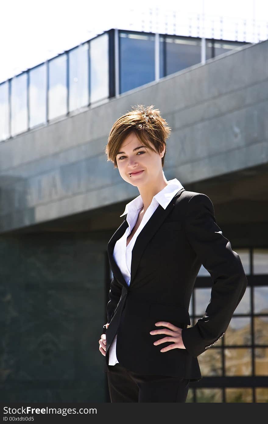 Smiling businesswoman against urban background. Smiling businesswoman against urban background.