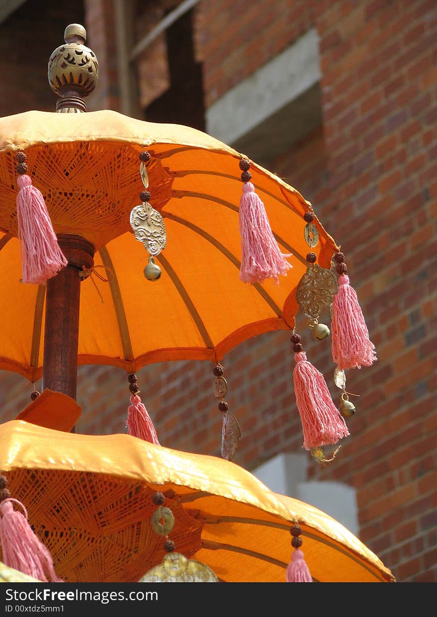 Eastern Umbrella against a brick wall building