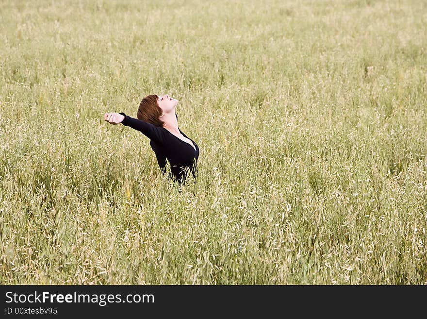 Woman feeling freedom in a field. Woman feeling freedom in a field.