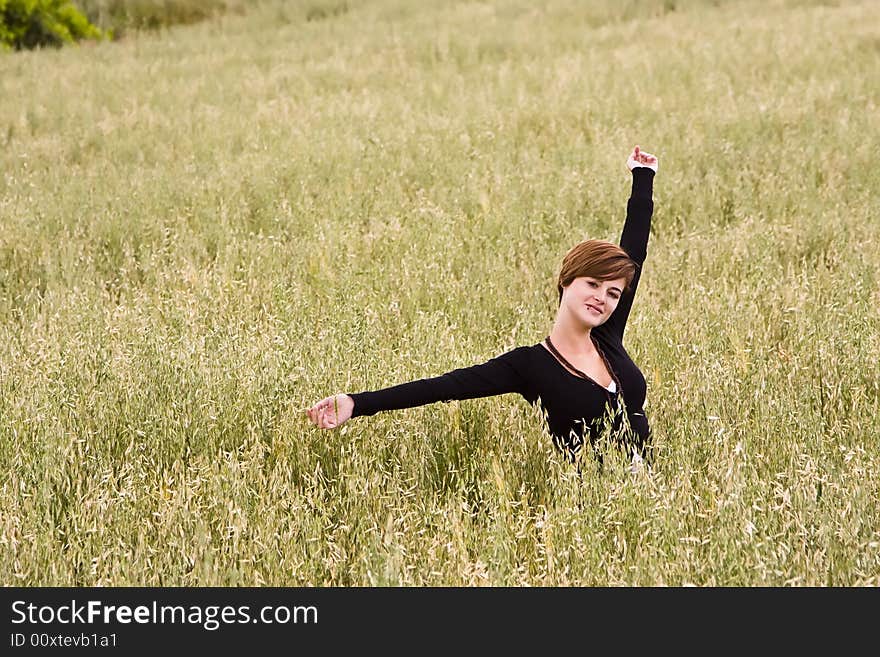 Woman feeling freedom in a field. Woman feeling freedom in a field.