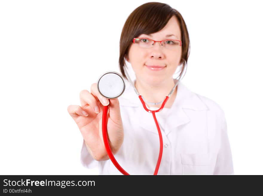 Young female doctor isolated on white, with red stethoscope in focus, person is blurred. Young female doctor isolated on white, with red stethoscope in focus, person is blurred