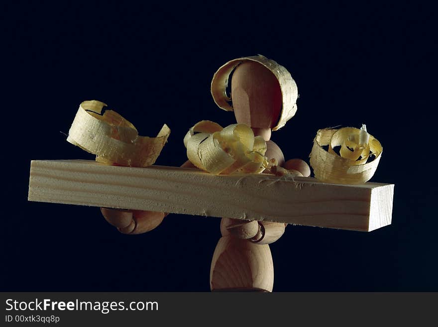 The wooden doll representing the waiter on a black background