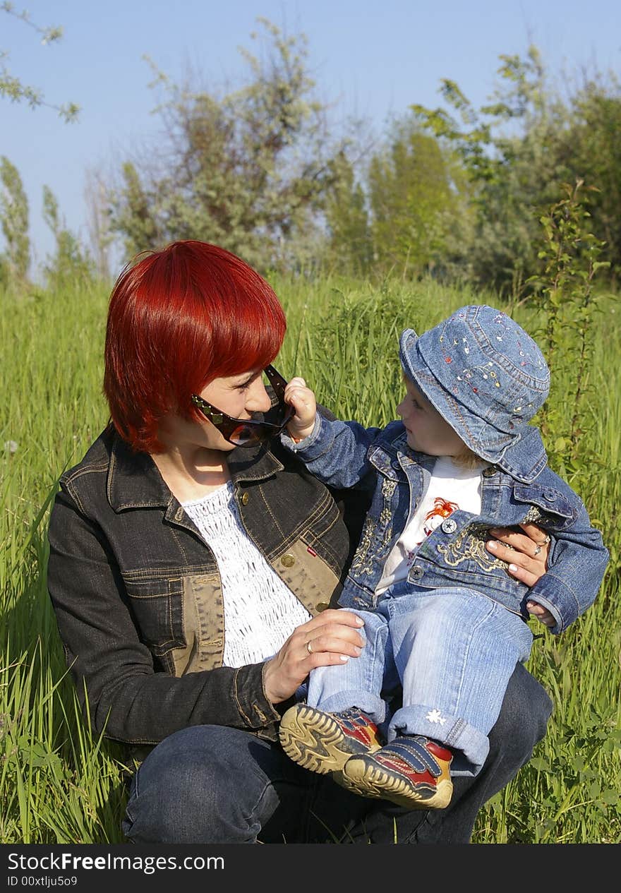 The little girl and her mum on a grass