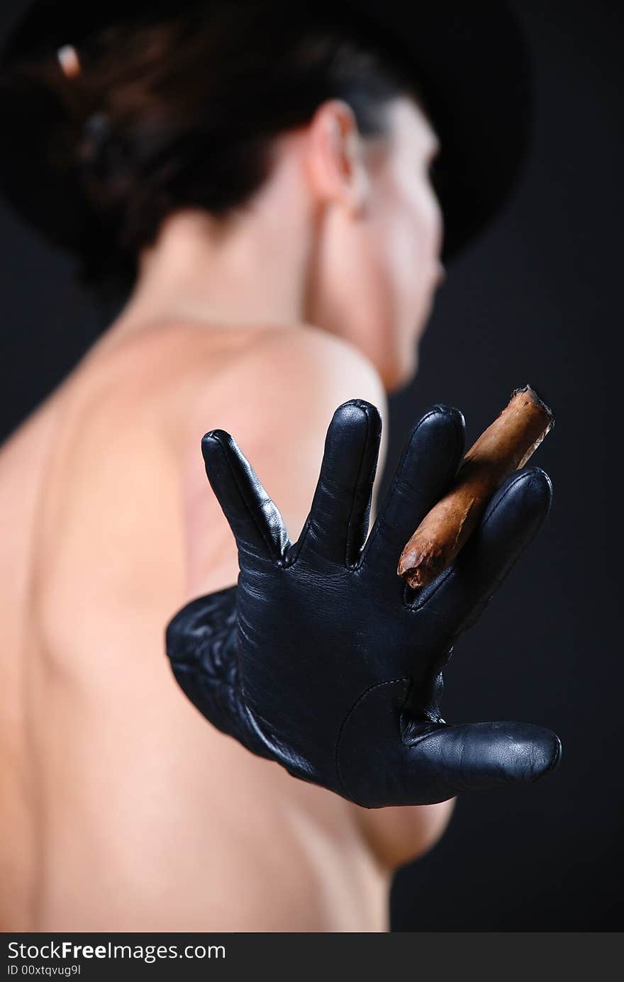 Bare girl in black gloves and a cigar in a hand. Bare girl in black gloves and a cigar in a hand