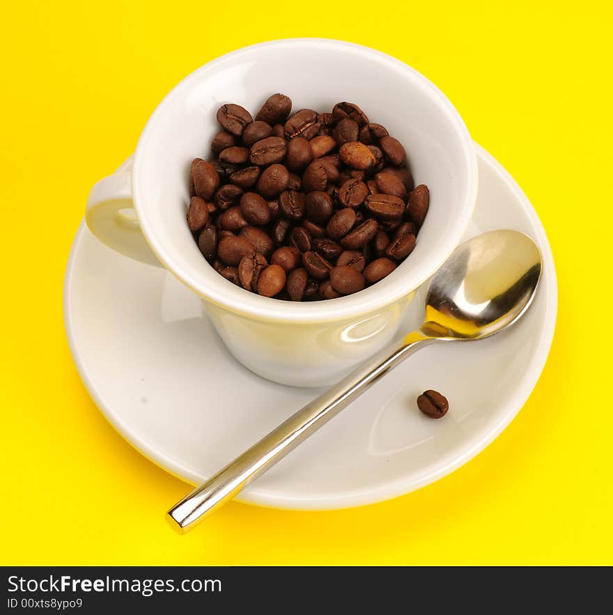 Macro studio shot of a cup of coffee beans.