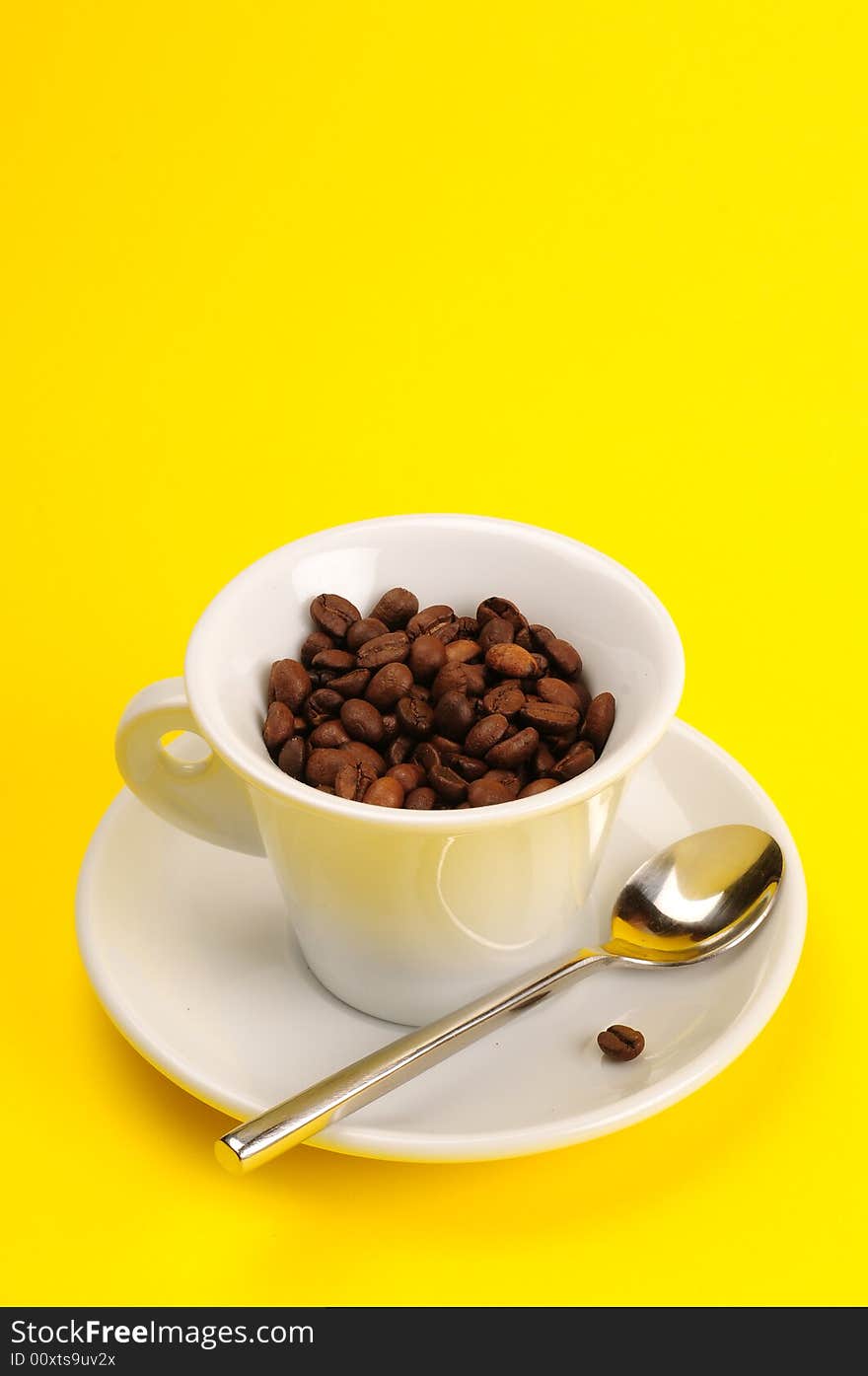 Macro studio shot of a cup of coffee beans.