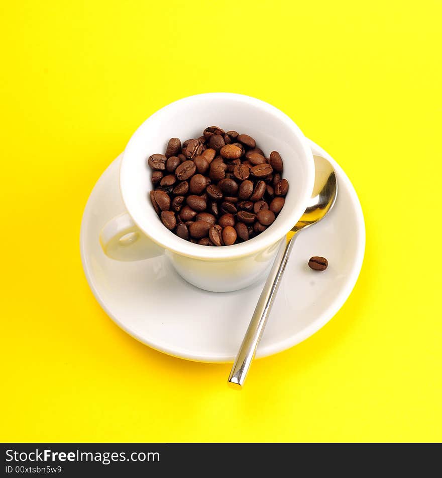 Macro studio shot of a cup of coffee beans.