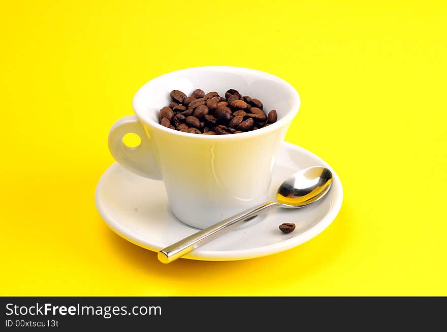 Macro studio shot of a cup of coffee beans.