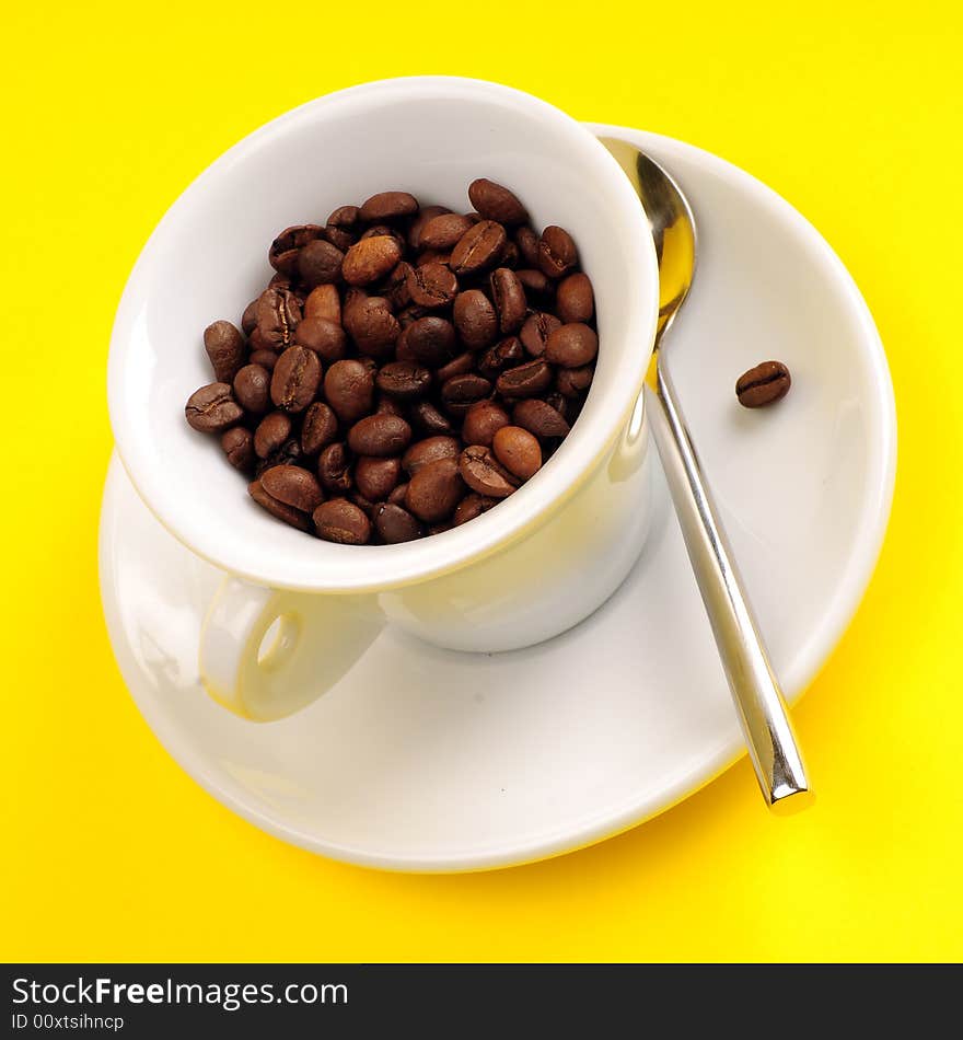 Macro studio shot of a cup of coffee beans.