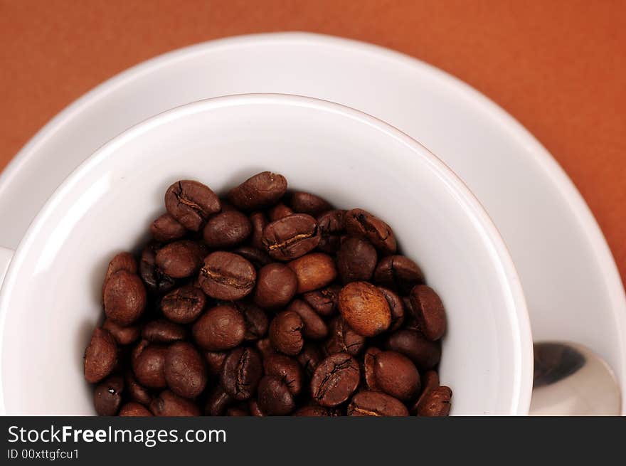 Macro studio shot of a cup of coffee beans.