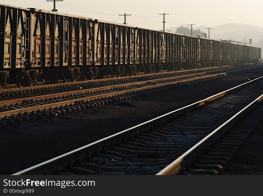 Freight cars ready to depart in a railway station in dawn.