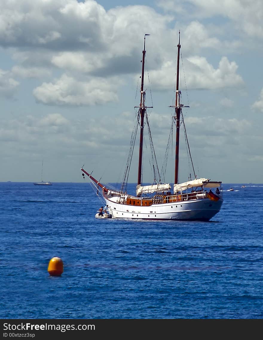 Two Boaters make their way to their yacht in a dingy. Two Boaters make their way to their yacht in a dingy