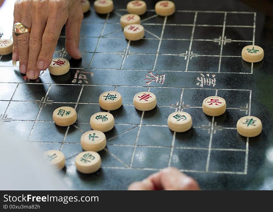 Elderly man playing Chinese Chess in a public park. Elderly man playing Chinese Chess in a public park