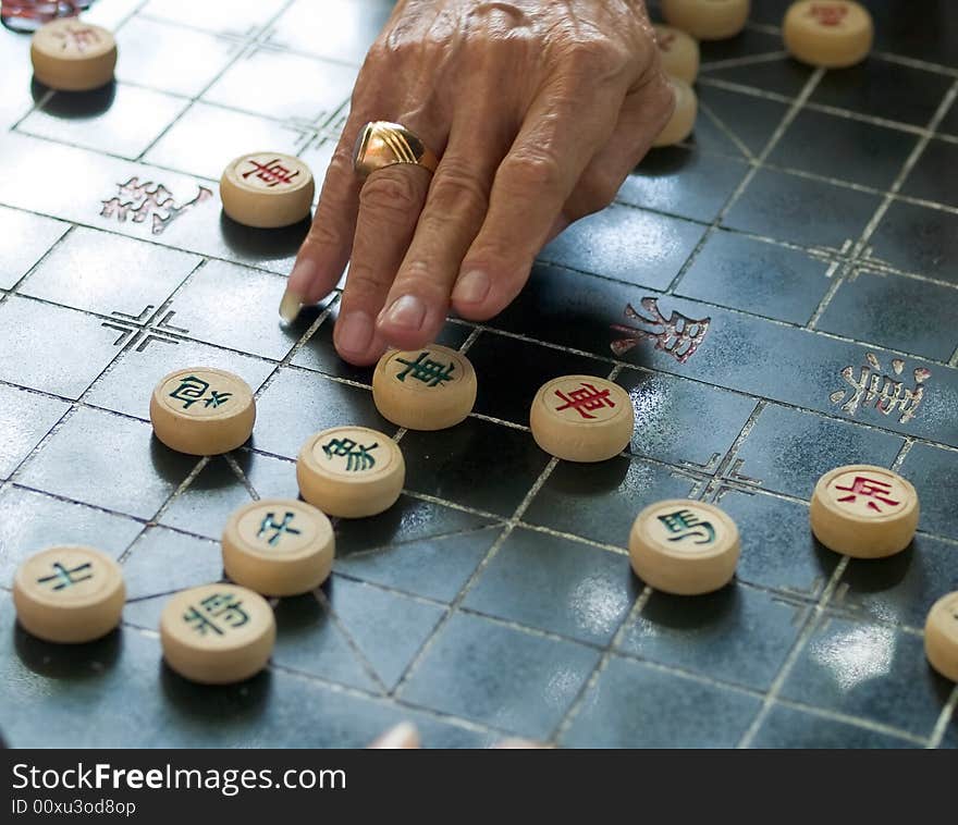 Elderly man playing Chinese Chess in a public park. Elderly man playing Chinese Chess in a public park