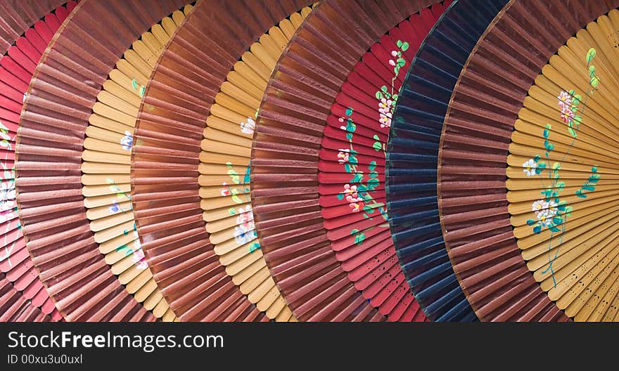 Large Chinese bamboo and paper fans arrange in an overlapping pattern. Large Chinese bamboo and paper fans arrange in an overlapping pattern