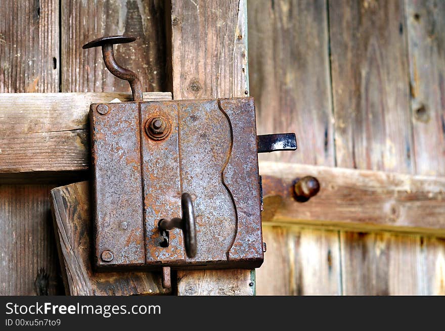 Old door lock at a wooden door