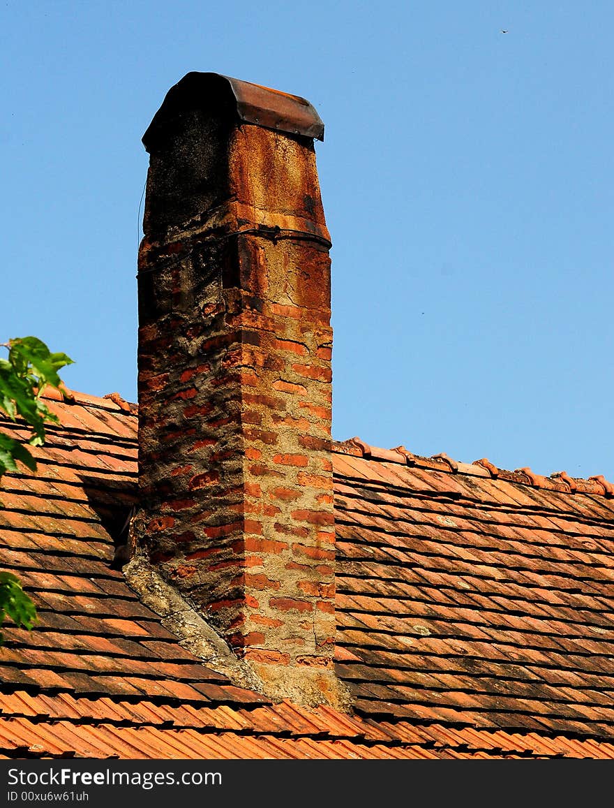 A view with tiles on the roof over blue sky. A view with tiles on the roof over blue sky