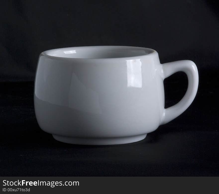 White cup on a black background