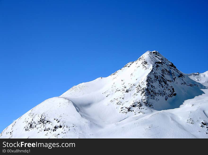 Snowy Alps in Switzerland under blue sky. Snowy Alps in Switzerland under blue sky