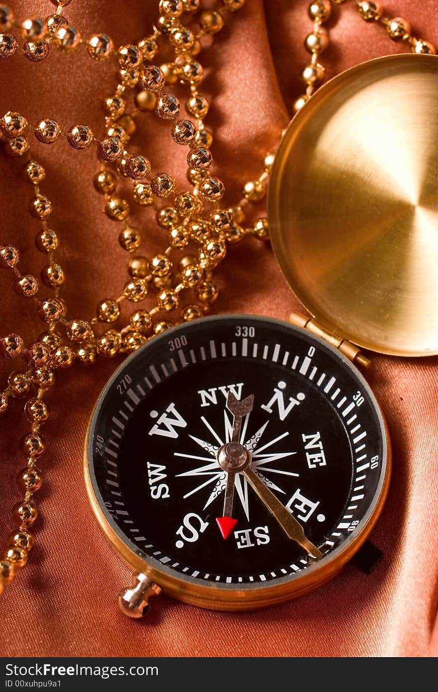 Compass and jewelry still life. Compass and jewelry still life