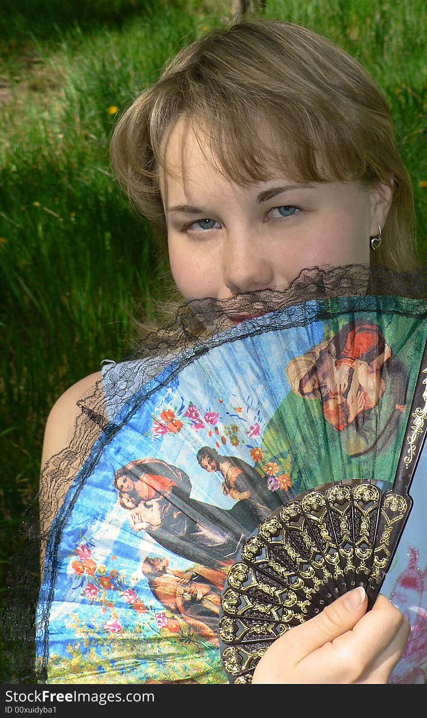 Pretty girl with fan in hand