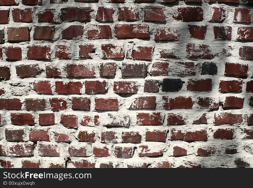 A wall of very weathered and aged bricks. A wall of very weathered and aged bricks.