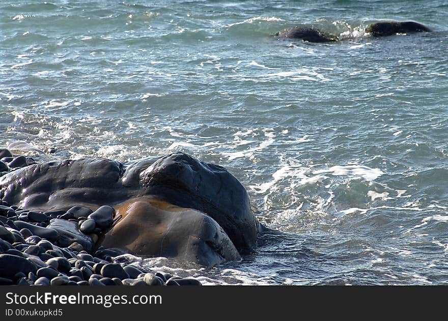 Seashore with stones during surf.