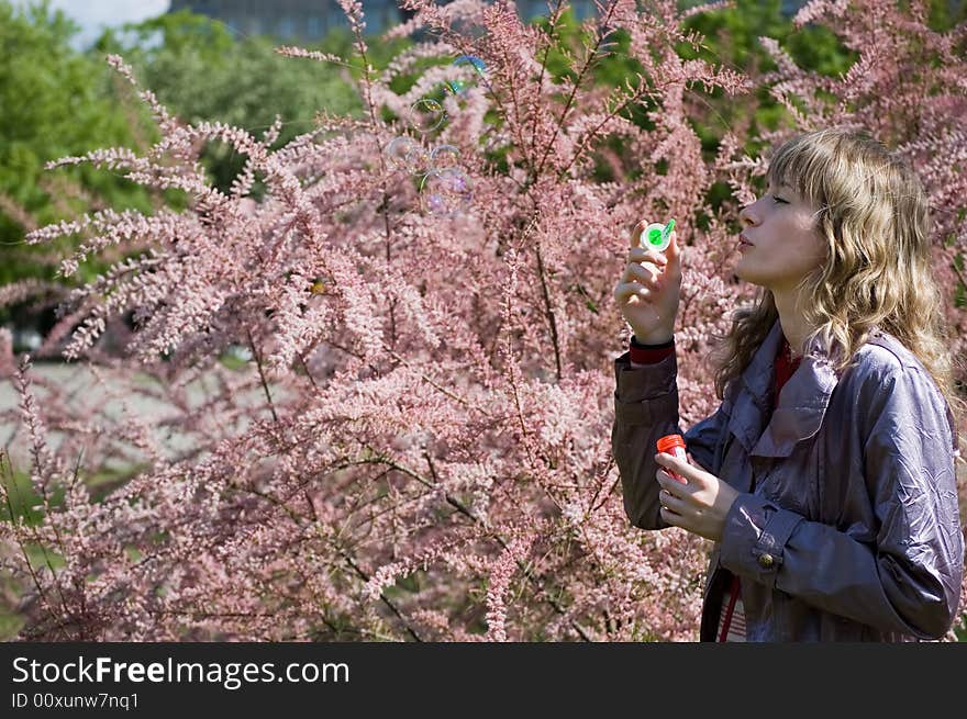 Girl blowing bubble in the park