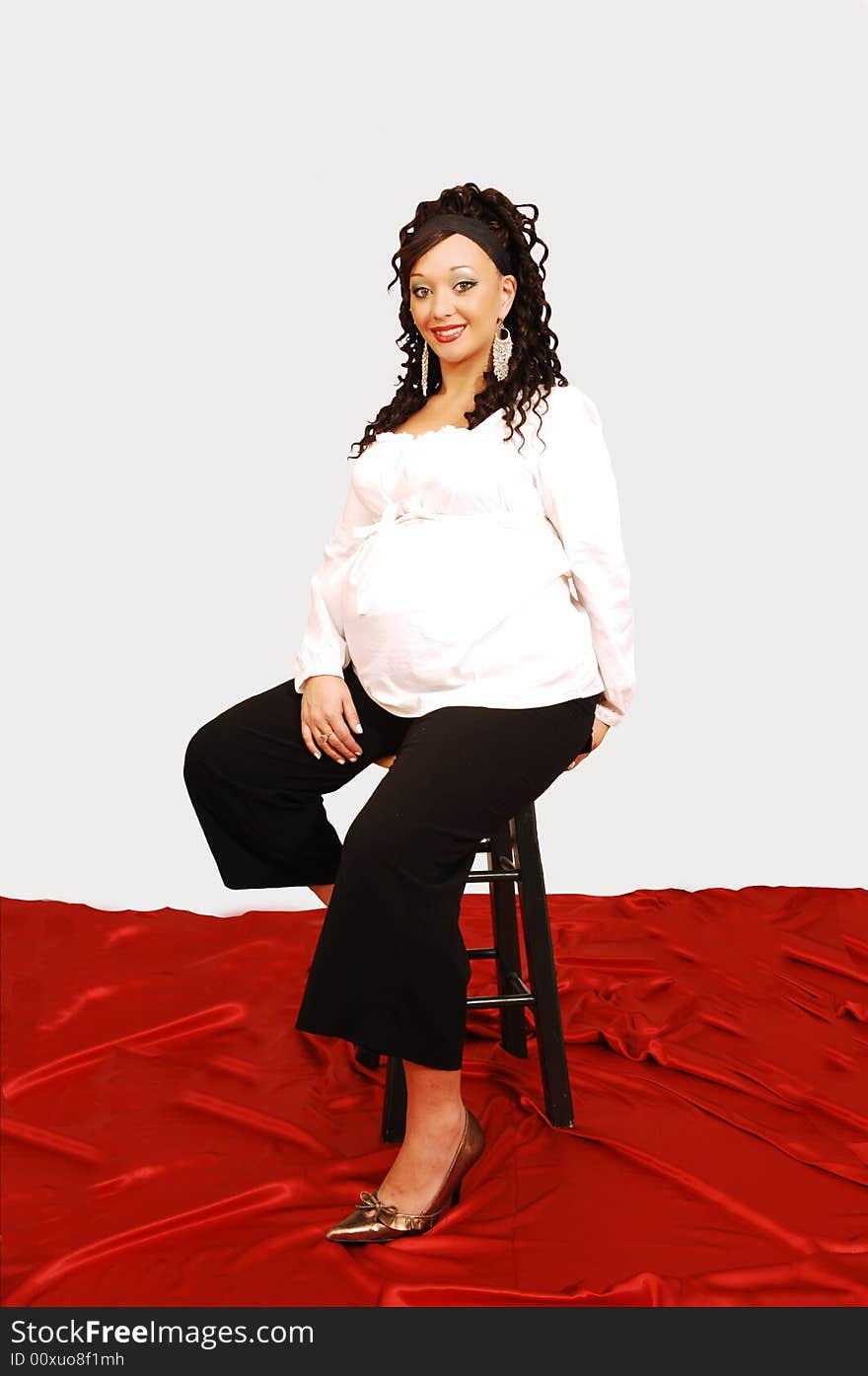 An beautiful girl in black pants and white top is shooing her big belly and is so
proud of the baby. An beautiful girl in black pants and white top is shooing her big belly and is so
proud of the baby.