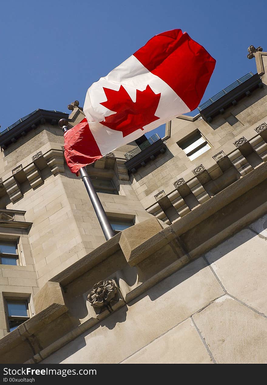 Building with the Canadian flag in the wind