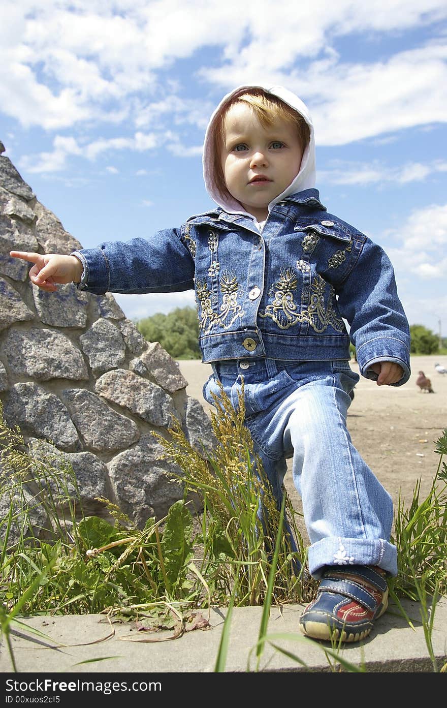 The clever little girl on a background of the sky