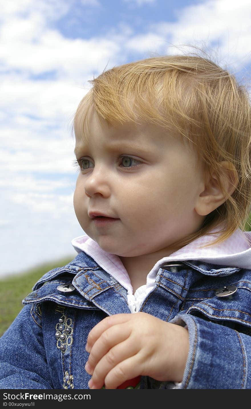 Little Girl On A Background Of The Sky