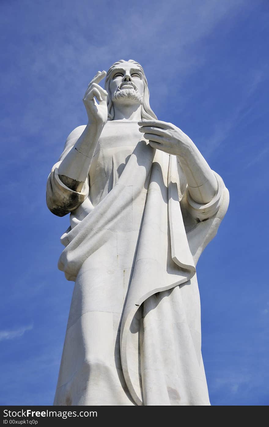 Detail of Jesus Christ statue in Havana against blue sky