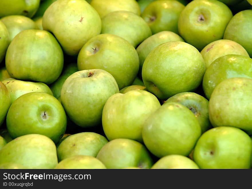 Pile of fresh green apples at for display at market