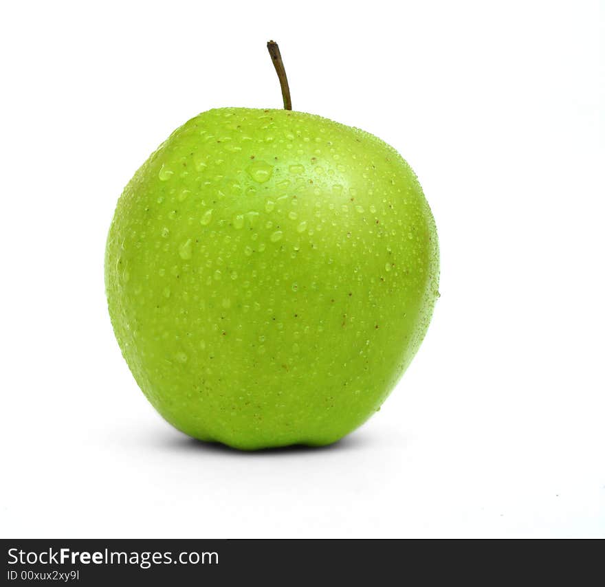 A fresh green apple with water drops