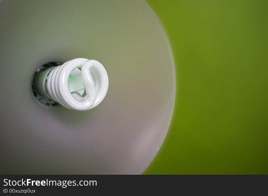 Go green with energy saving light bulbs! Picture shows inside of a lamp with a green wall/backdrop behind it. Go green with energy saving light bulbs! Picture shows inside of a lamp with a green wall/backdrop behind it.