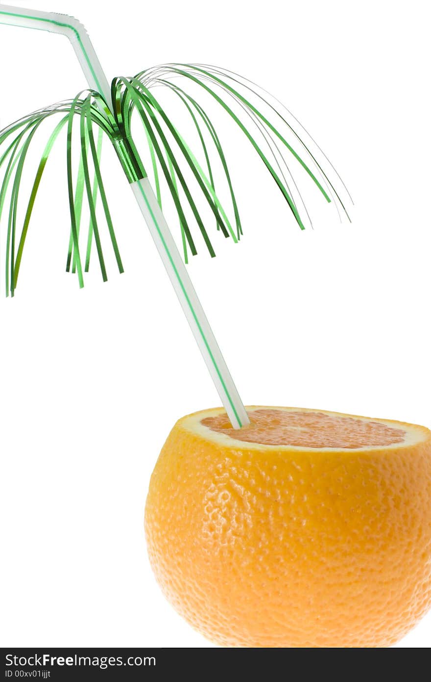 Chopped orange with green decorated drinking straw