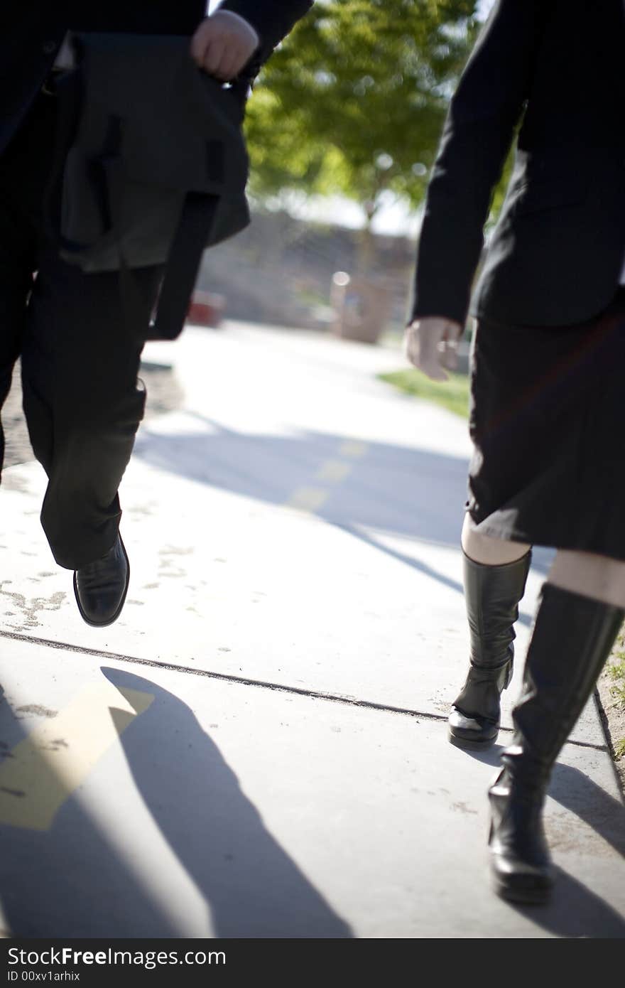 Businessman and businesswoman walking in same direction. Businessman and businesswoman walking in same direction