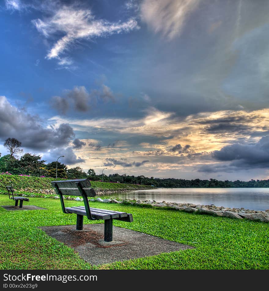 Empty Park Benches At Sunset